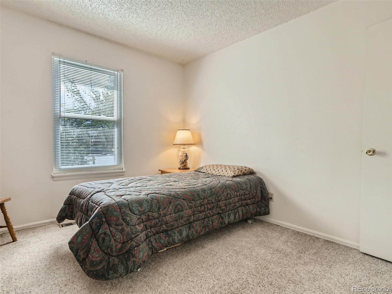 1632 South Rifle Street Aurora, CO 80017 - Photo 21 of 26 a bedroom with a bed and window