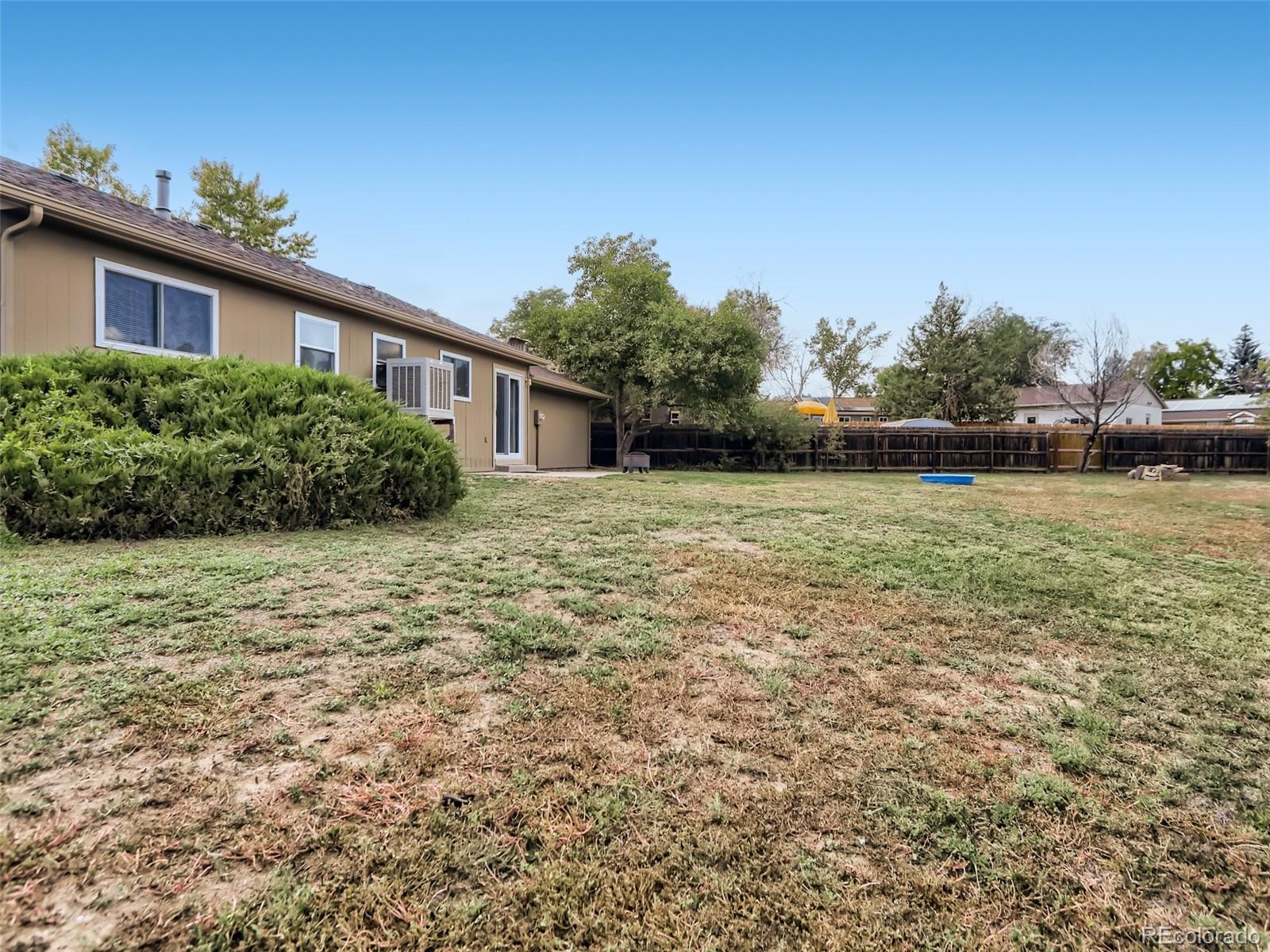 1632 South Rifle Street Aurora, CO 80017 - Photo 24 of 26 a backyard of a house with lots of green space