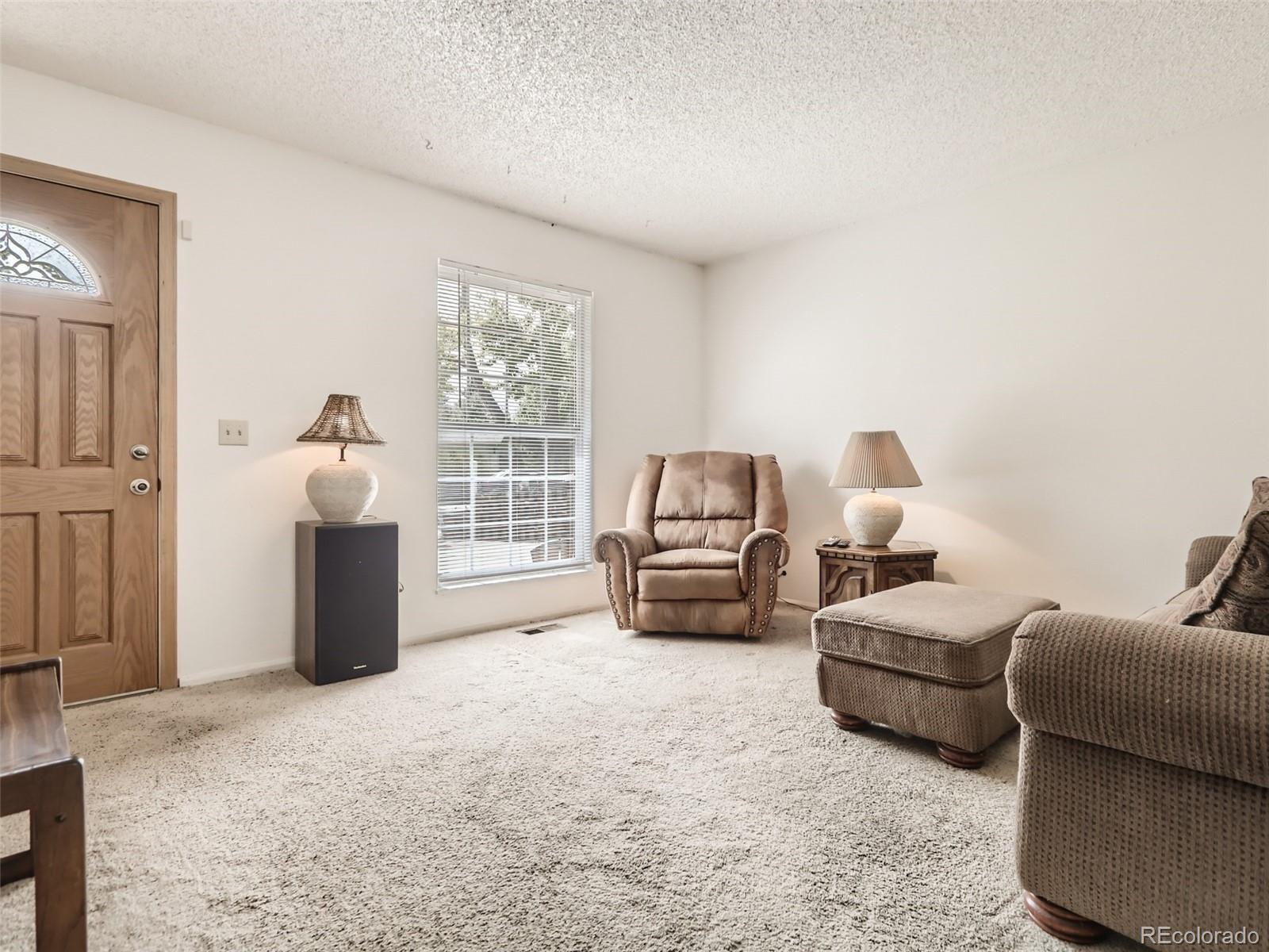 1632 South Rifle Street Aurora, CO 80017 - Photo 6 of 26 a bedroom with furniture and a window