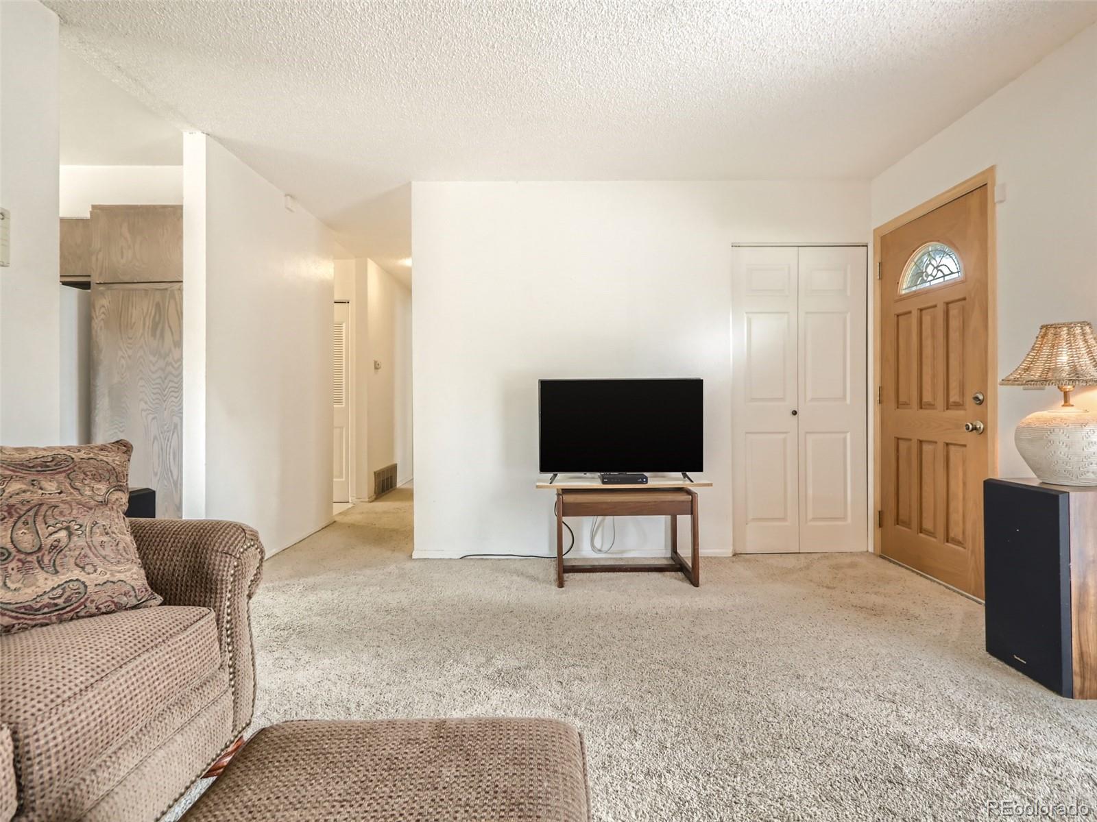 1632 South Rifle Street Aurora, CO 80017 - Photo 8 of 26 a living room with furniture and a flat screen tv