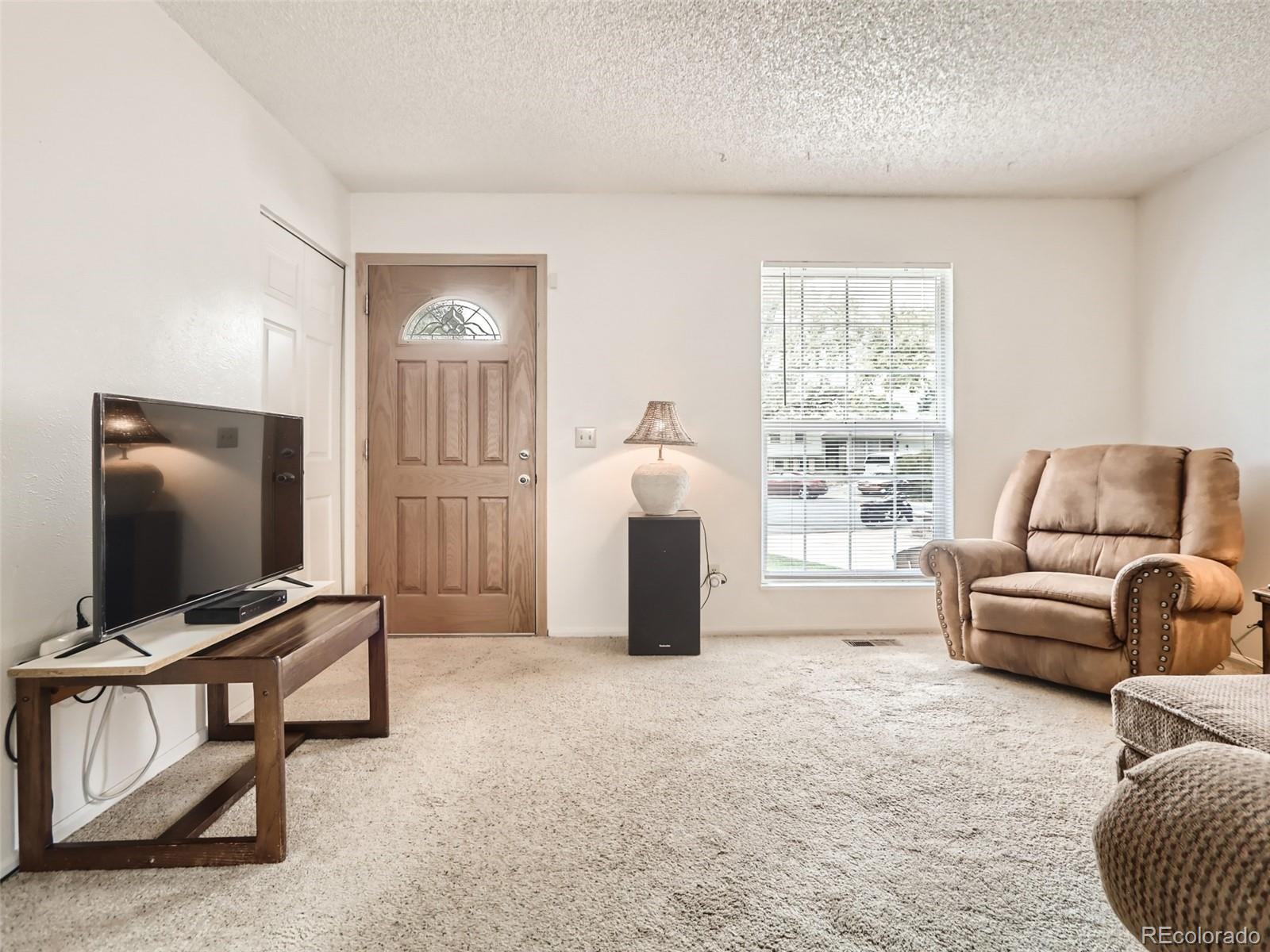 1632 South Rifle Street Aurora, CO 80017 - Photo 9 of 26 a living room with furniture and a flat screen tv
