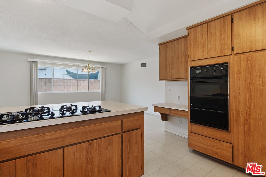 19131 Tulsa Street Porter Ranch, CA 91326 - Photo 16 of 43 a kitchen with a refrigerator and cabinets