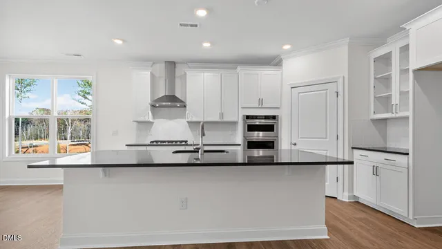 a kitchen with stainless steel appliances granite countertop a stove and a sink