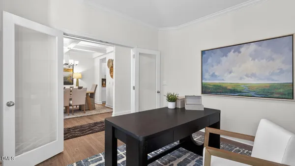 a living room with furniture and a dining table with kitchen view