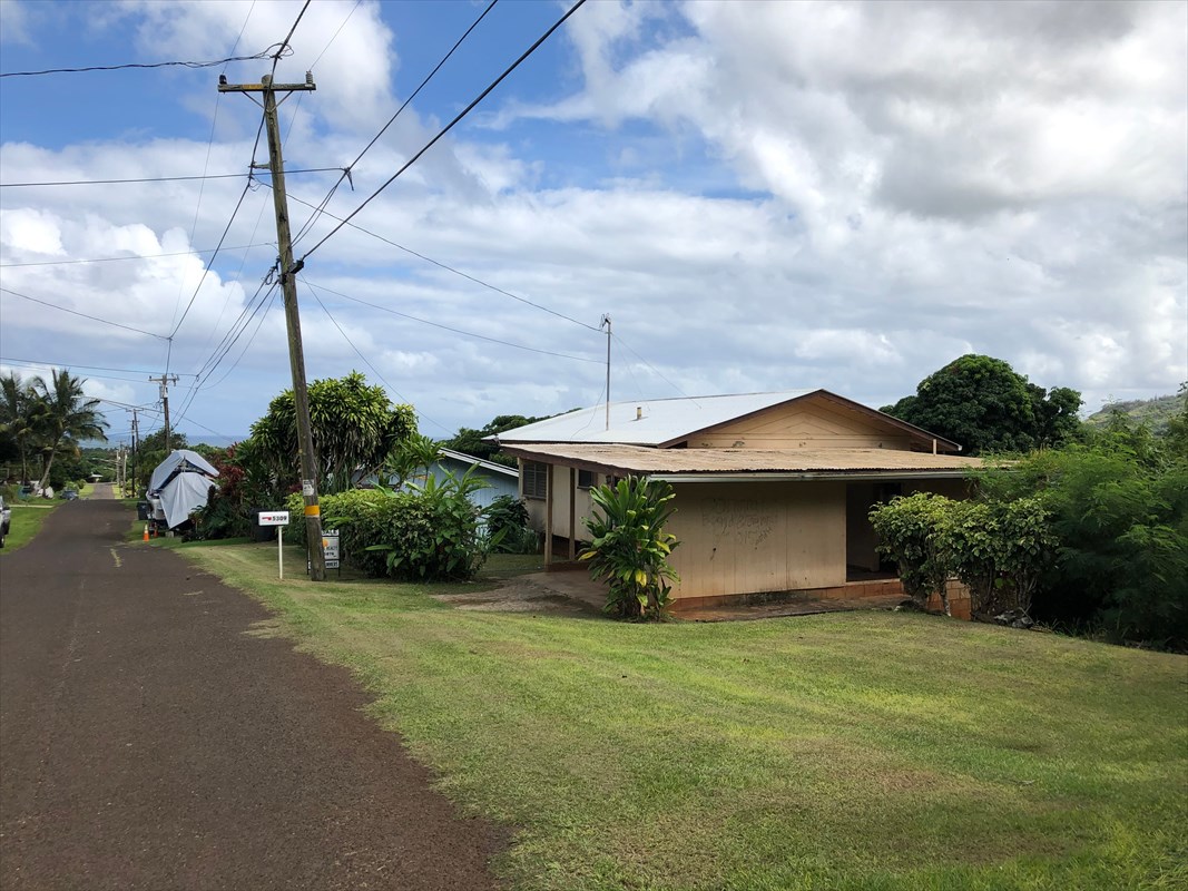5309 Kihei Road Kapaa, HI 96746 - Photo 1 of 20 a front view of a house with a yard and garage