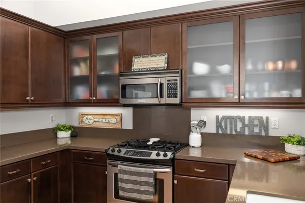 a kitchen with stainless steel appliances granite countertop a stove and a microwave