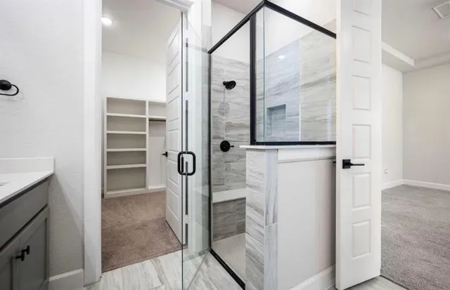 a spacious bathroom with a sink a mirror a bathtub and shower