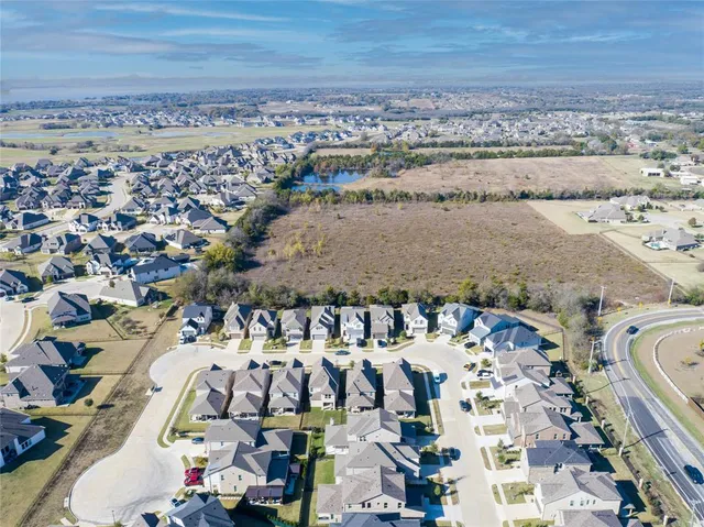 an aerial view of residential houses with outdoor space