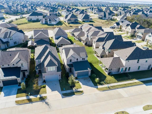 an aerial view of a house with a yard