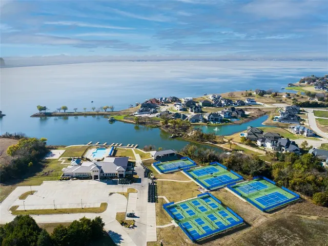 a view of a terrace with a bench and lake view