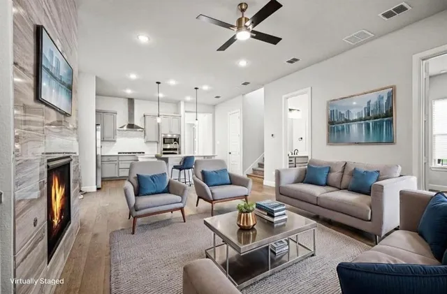 a bedroom with a large bed couch and windows