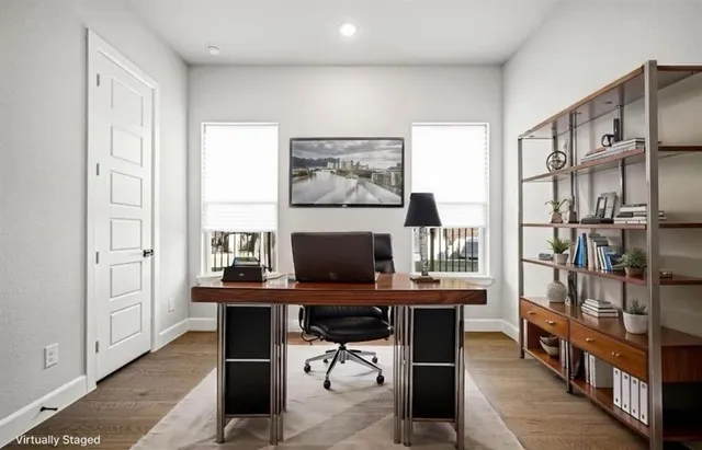 a kitchen with stainless steel appliances kitchen island a white cabinets and wooden floor