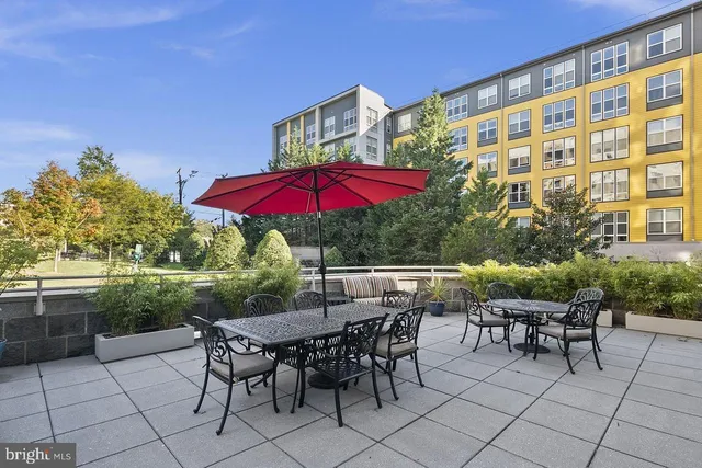 an outdoor space with furniture and umbrella