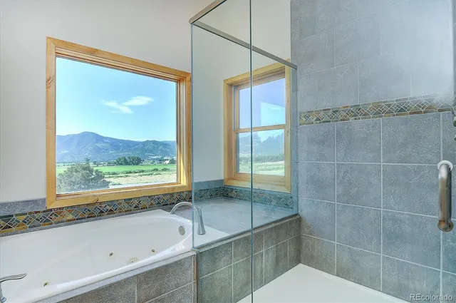 a view of a balcony with wooden floor and fence