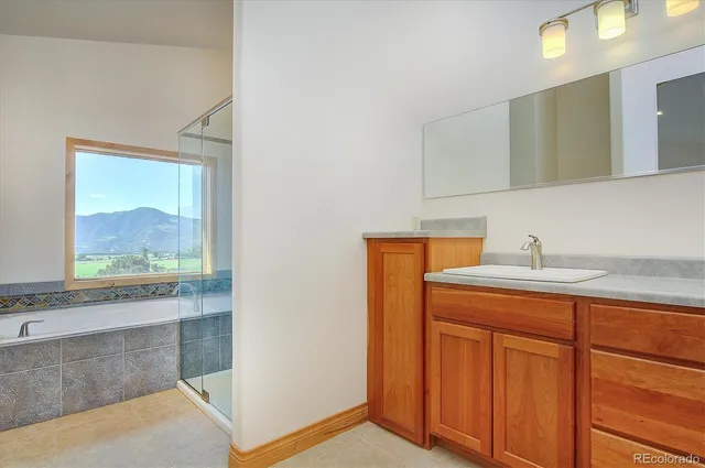 a backyard of a house with wooden deck and furniture