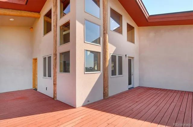 a living room with furniture a large window and a flat screen tv