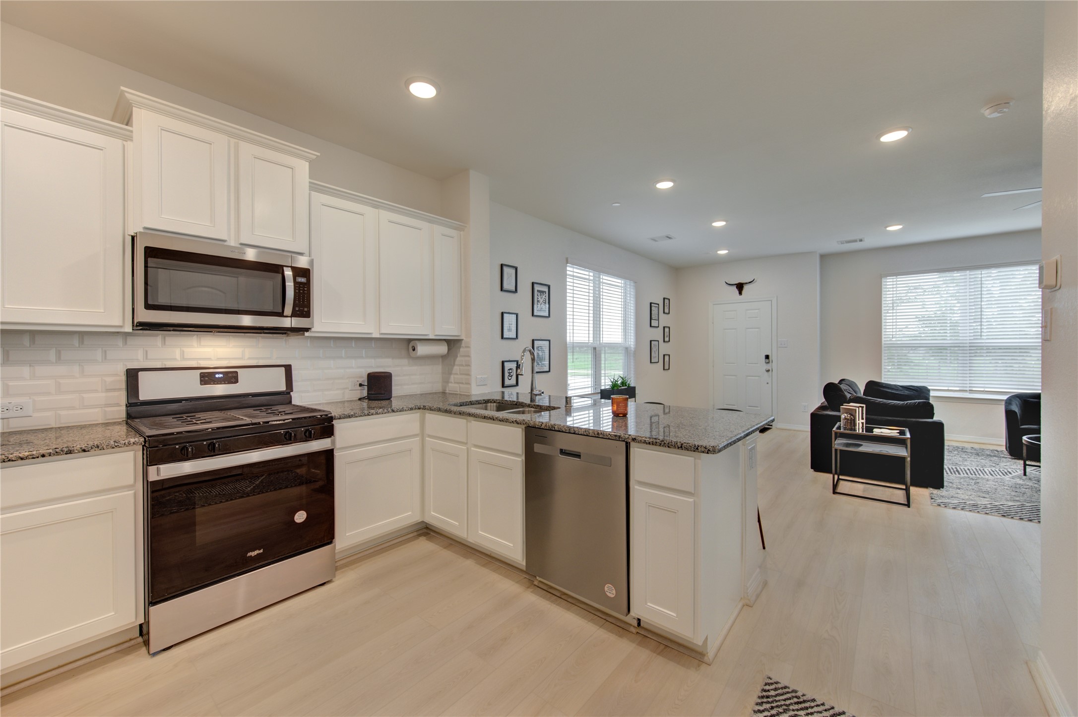 8030 Scanlan Trace Missouri City, TX 77459 - Photo 6 of 17 a kitchen with stainless steel appliances a stove sink microwave and cabinets