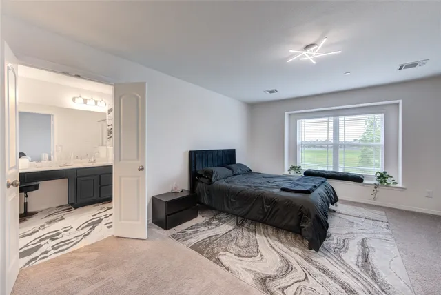 a kitchen with stainless steel appliances granite countertop a stove top oven a sink a dining table and chairs with wooden floor