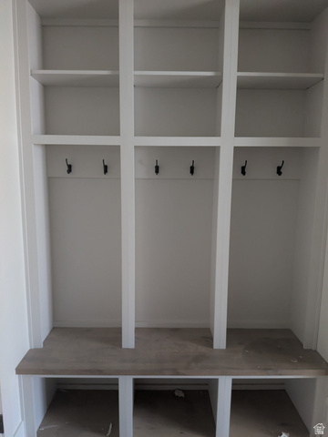 2771 West Aurora Avenue Mapleton, UT 84664 - Photo 10 of 39 Built-in mudroom storage featuring white cabinetry, a wood-finish bench, and six matte black hooks