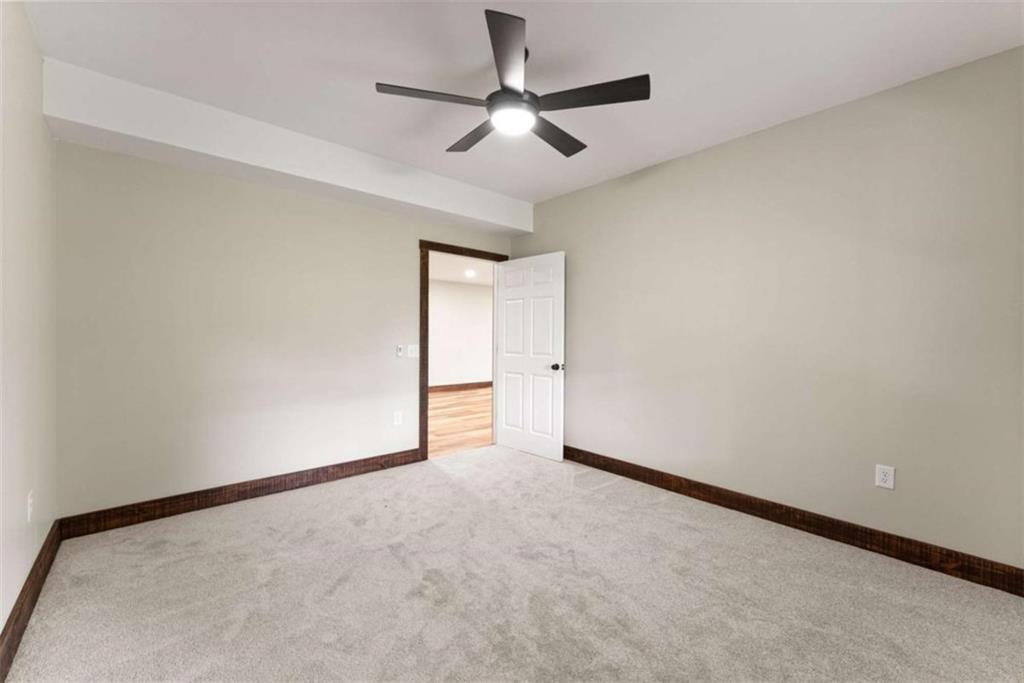707 South Fern Cove Road Sautee Nacoochee, GA 30571 - Photo 28 of 60 an empty room with a ceiling fan and carpet