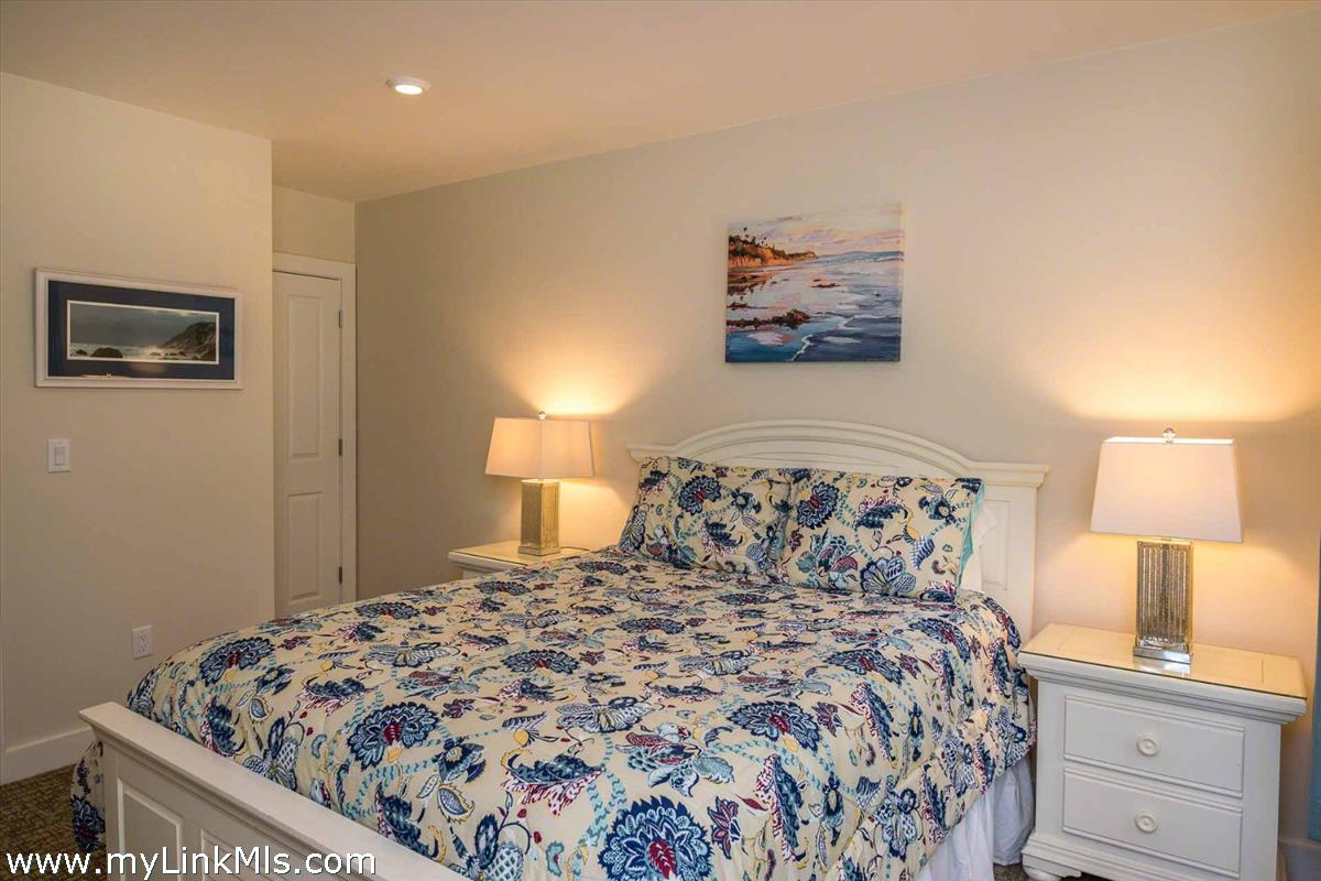 10 Codman Spring Road Edgartown, MA 02539 - Photo 15 of 30 a bedroom with a bed and a lamp