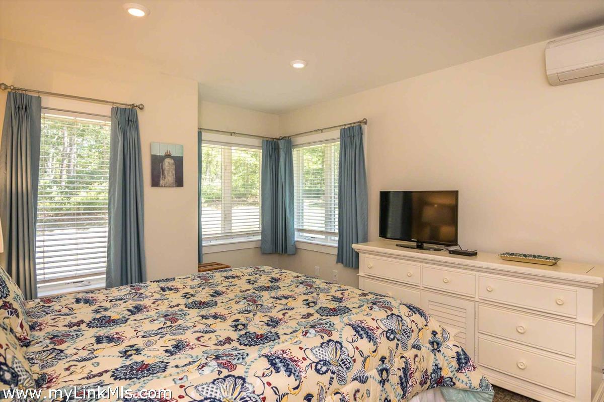 10 Codman Spring Road Edgartown, MA 02539 - Photo 16 of 30 a bedroom with a bed and a flat screen tv