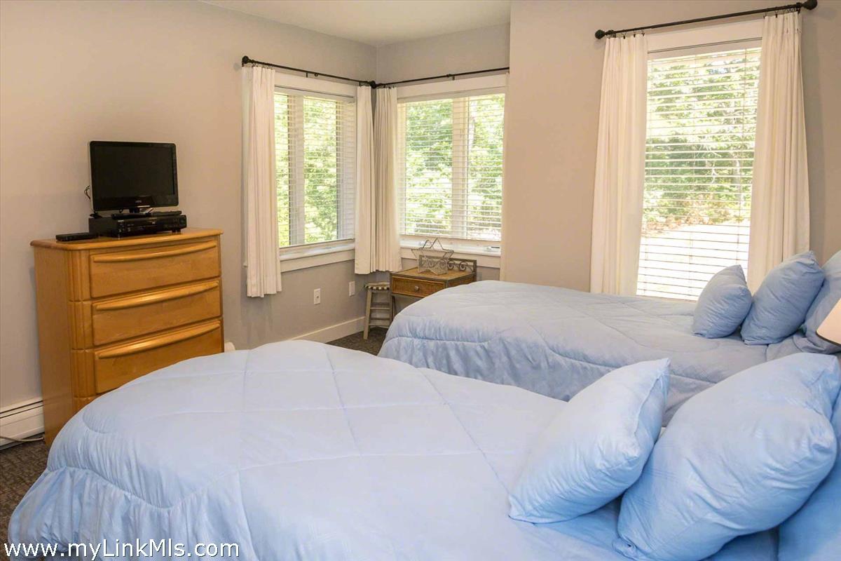 10 Codman Spring Road Edgartown, MA 02539 - Photo 18 of 30 a bedroom with a bed and a flat screen tv