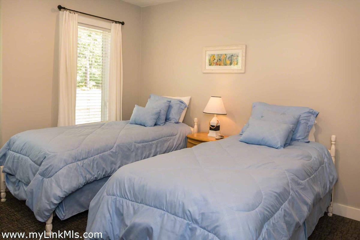 10 Codman Spring Road Edgartown, MA 02539 - Photo 19 of 30 a bedroom with two beds and a window