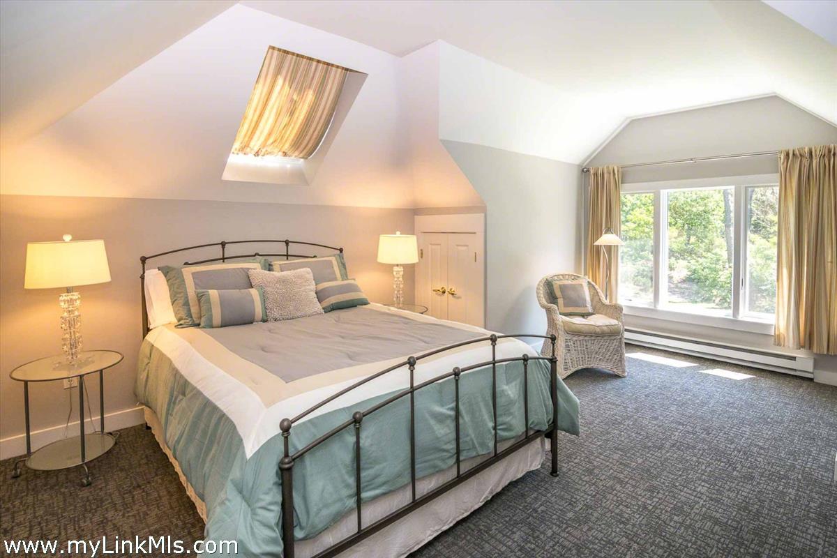 10 Codman Spring Road Edgartown, MA 02539 - Photo 20 of 30 a bedroom with a bed a window and flowerpot