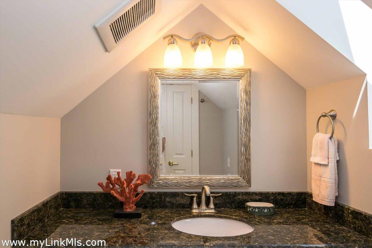 10 Codman Spring Road Edgartown, MA 02539 - Photo 22 of 30 a bathroom with a granite countertop sink and a mirror