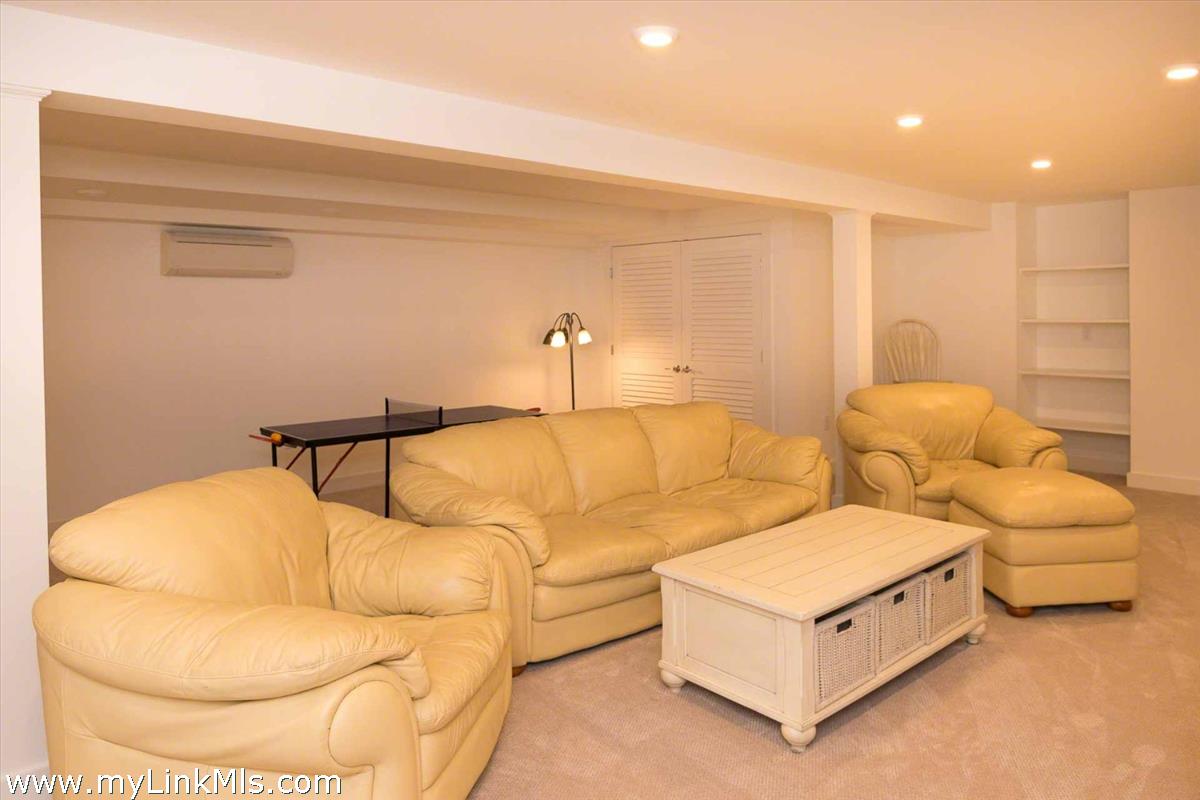 10 Codman Spring Road Edgartown, MA 02539 - Photo 23 of 30 a spacious bedroom with a bed and a couch