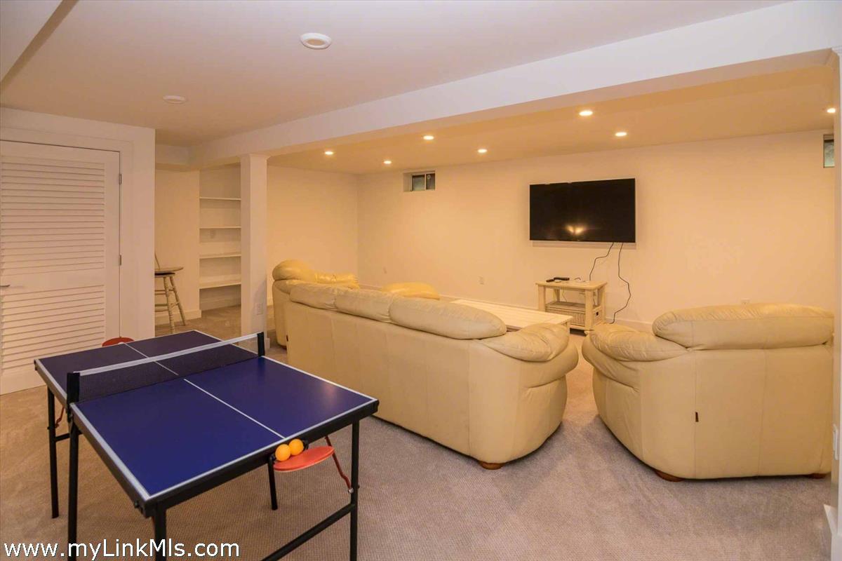 10 Codman Spring Road Edgartown, MA 02539 - Photo 24 of 30 a living room with a couch and a flat screen tv