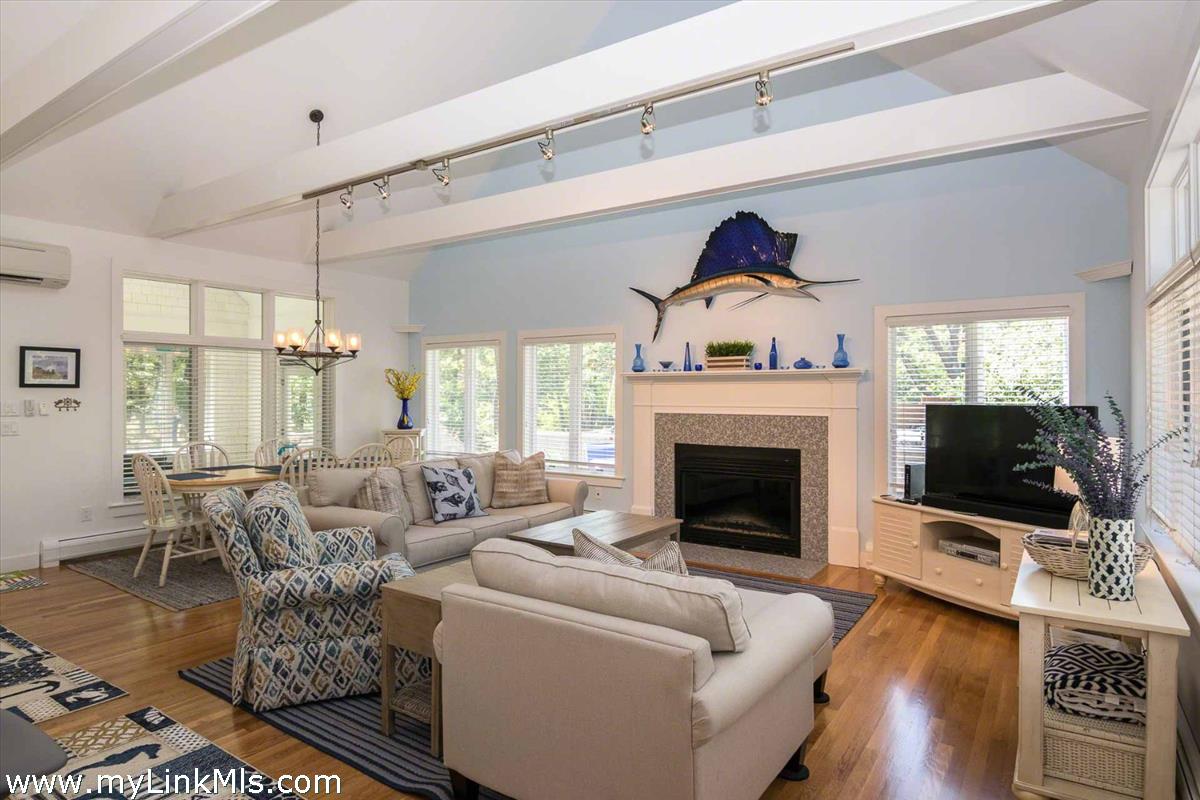 10 Codman Spring Road Edgartown, MA 02539 - Photo 4 of 30 a living room with furniture a fireplace and a flat screen tv