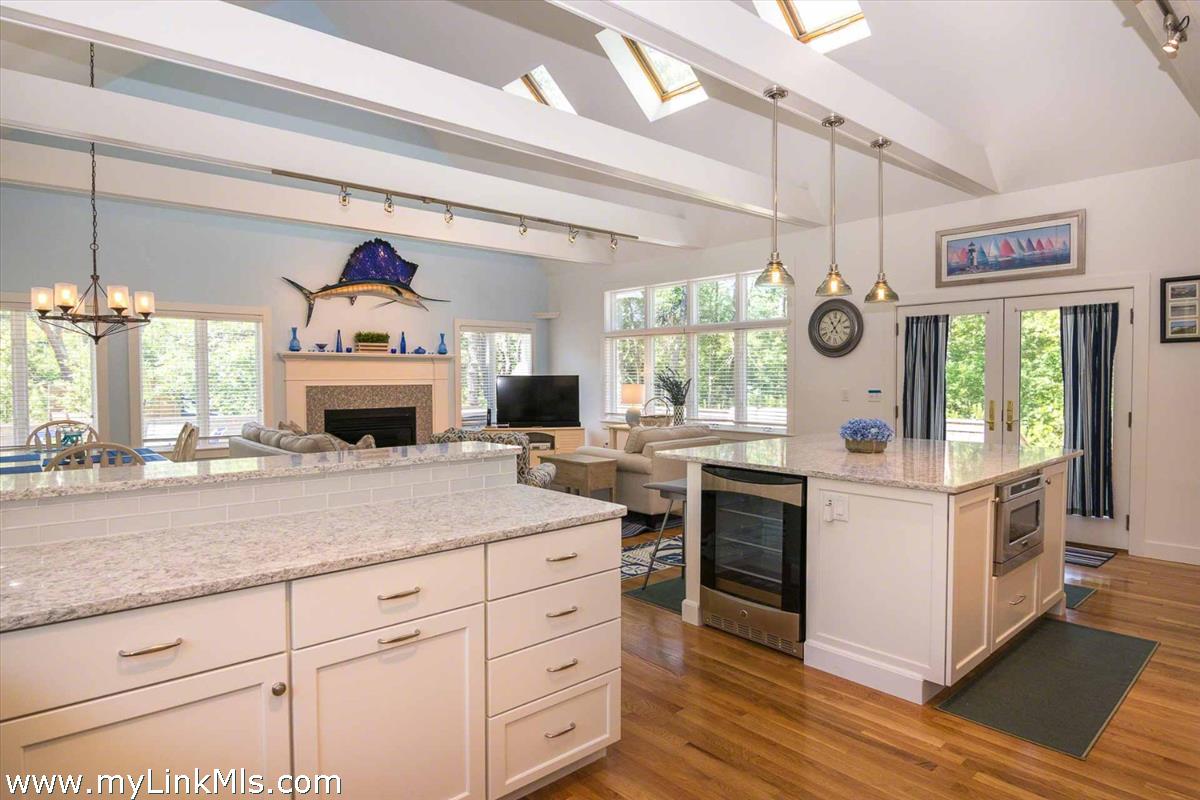 10 Codman Spring Road Edgartown, MA 02539 - Photo 6 of 30 a kitchen with kitchen island granite countertop a stove a sink and dishwasher with white cabinets