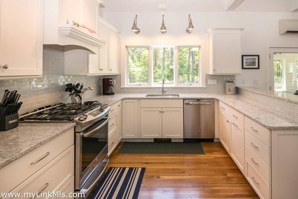 10 Codman Spring Road Edgartown, MA 02539 - Photo 7 of 30 a kitchen with a sink stove and cabinets