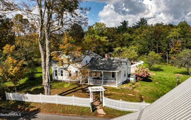a view of a house with backyard porch and sitting area