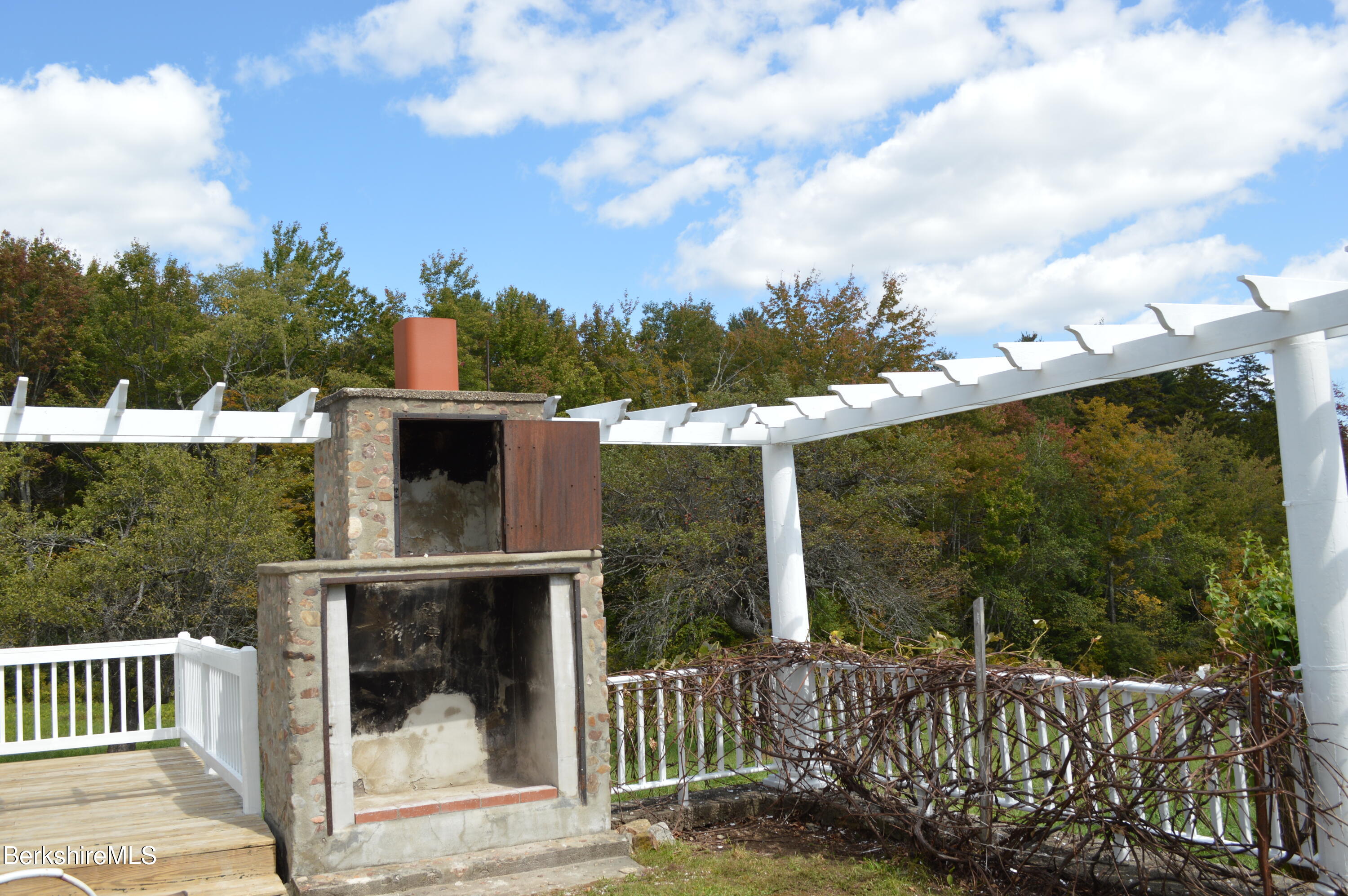 234 County Road Becket, MA 01223 - Photo 8 of 67 a view of a balcony with wooden floor and iron fence