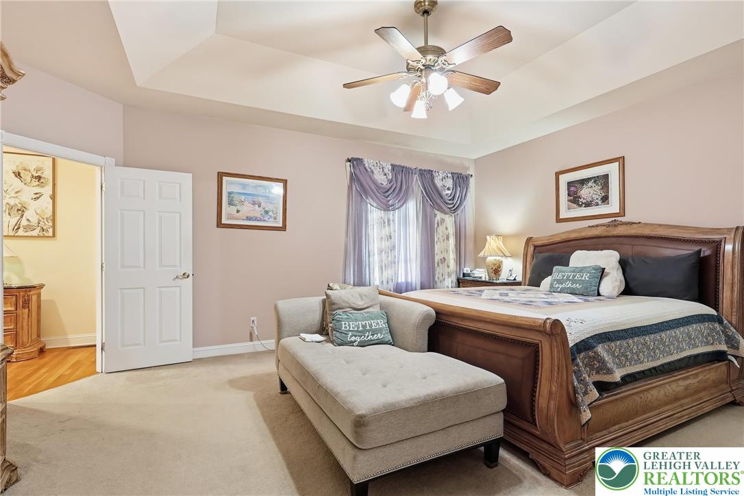 5217 Cider Press Road Schnecksville, PA 18078 - Photo 26 of 54 a spacious bedroom with a bed and a chandelier