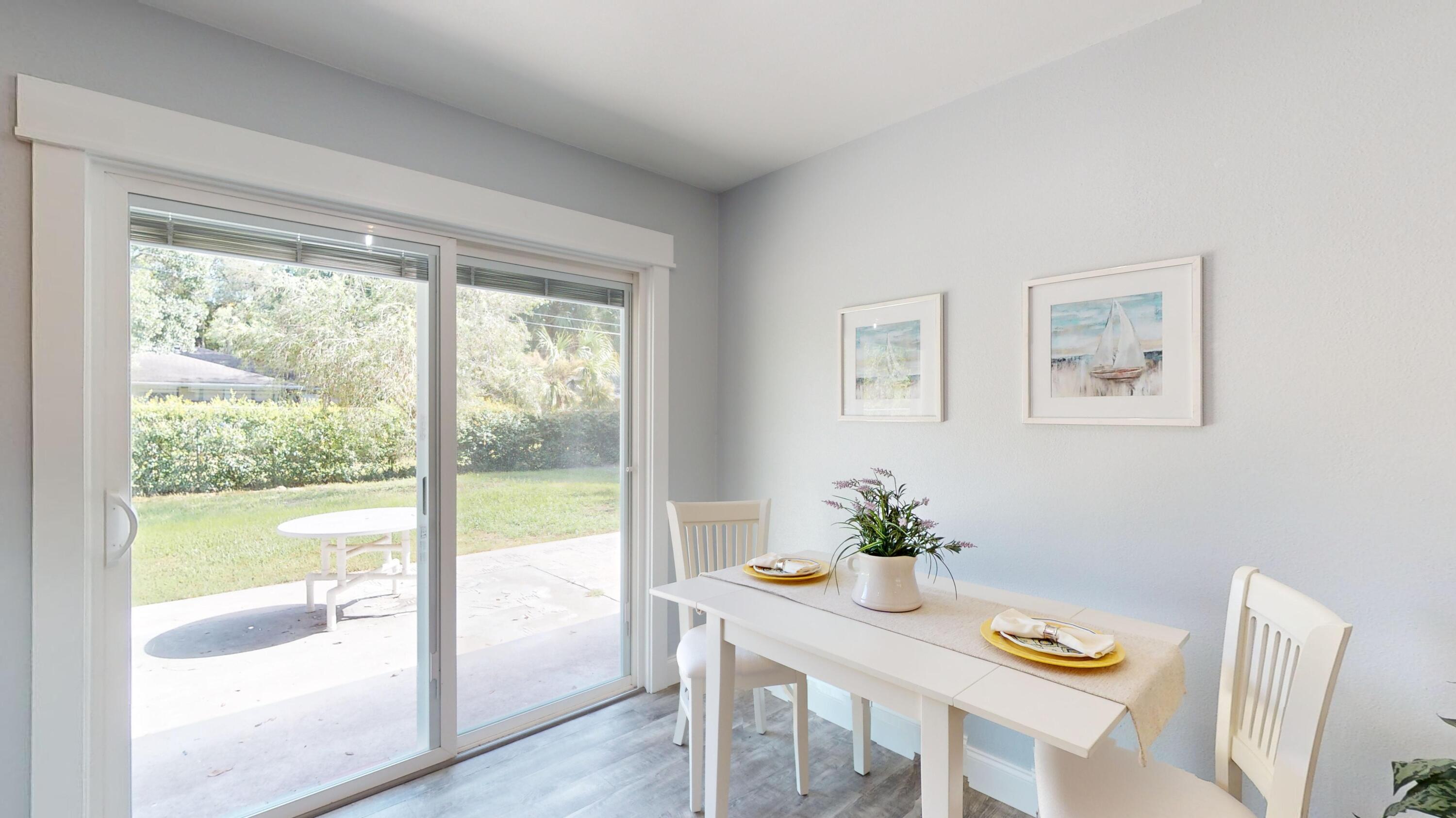 7606 Donlon Road Fort Pierce, FL 34951 - Photo 15 of 54 a dining room with furniture window and wooden floor