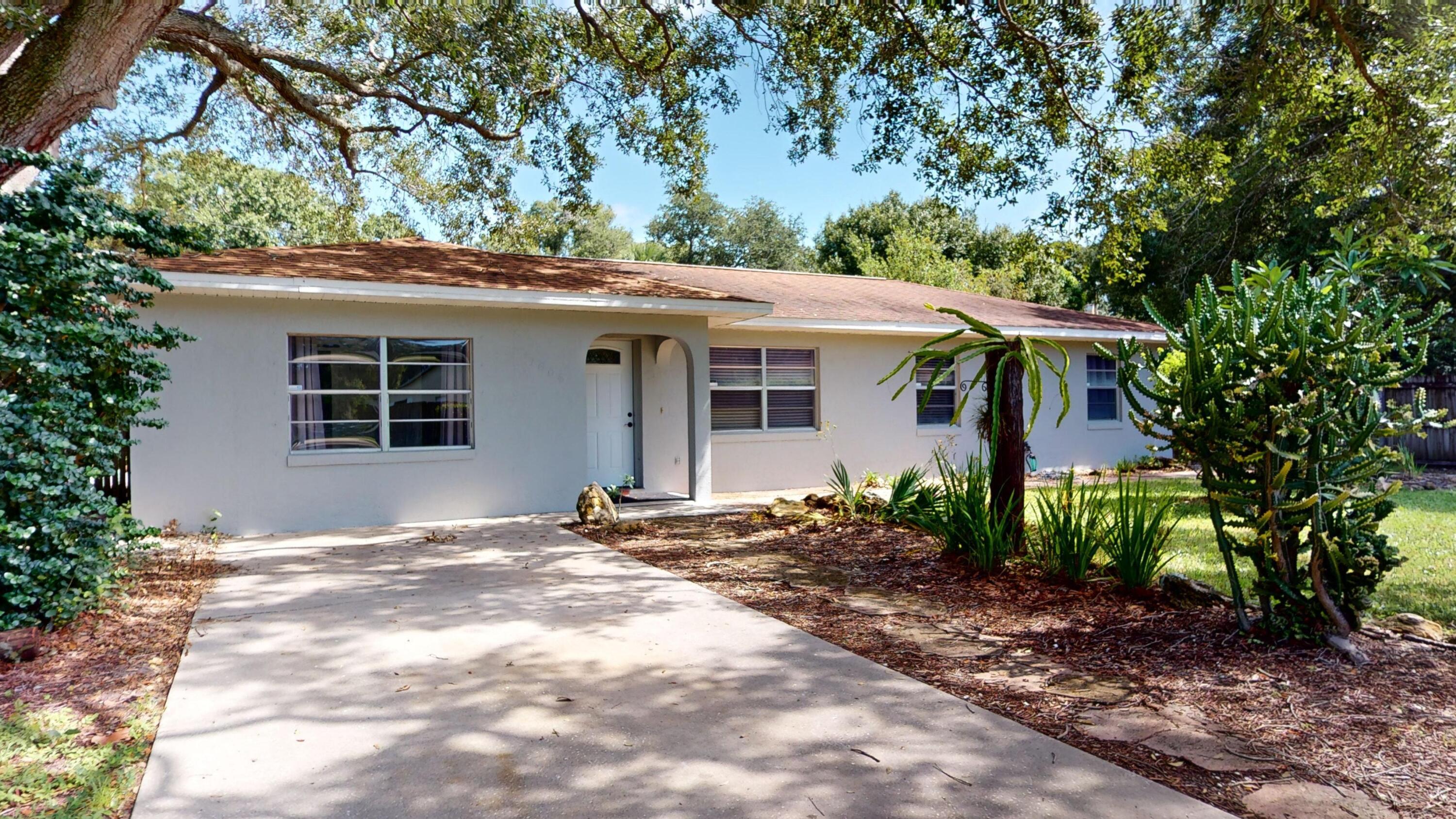 7606 Donlon Road Fort Pierce, FL 34951 - Photo 2 of 54 a front view of a house with garden