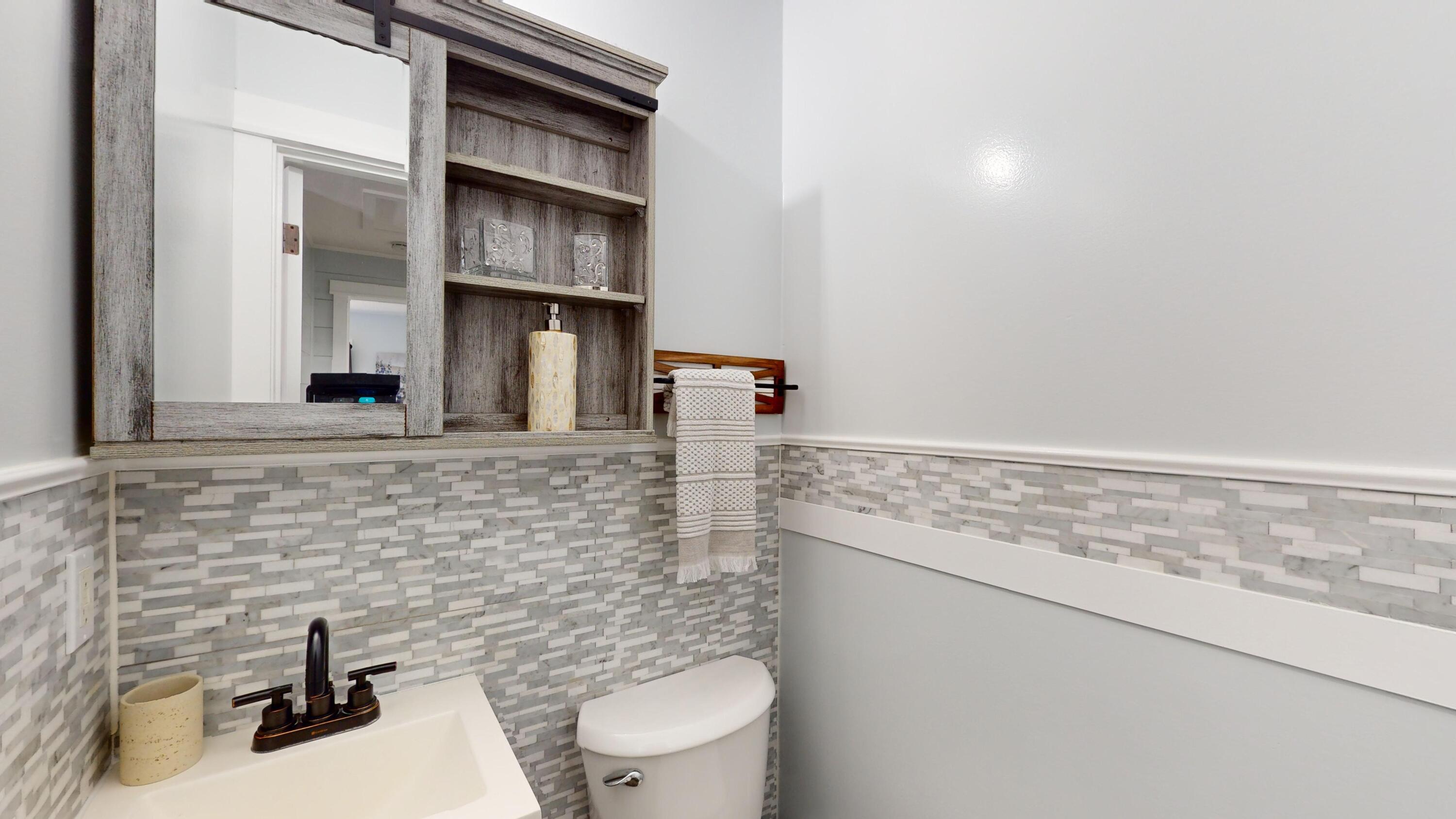 7606 Donlon Road Fort Pierce, FL 34951 - Photo 24 of 54 a bathroom with a sink a toilet and a mirror