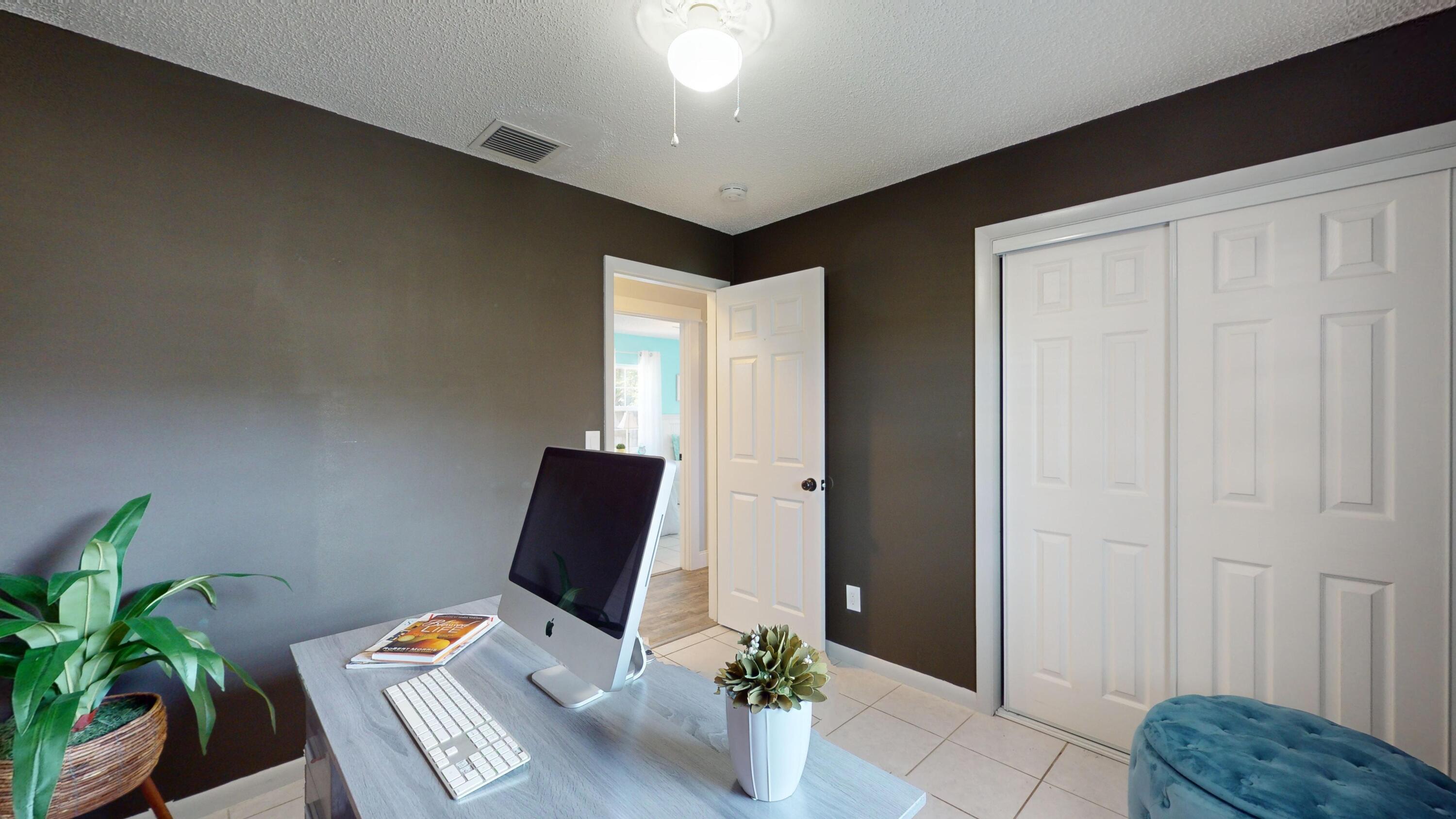 7606 Donlon Road Fort Pierce, FL 34951 - Photo 30 of 54 a workspace with furniture and wooden floor