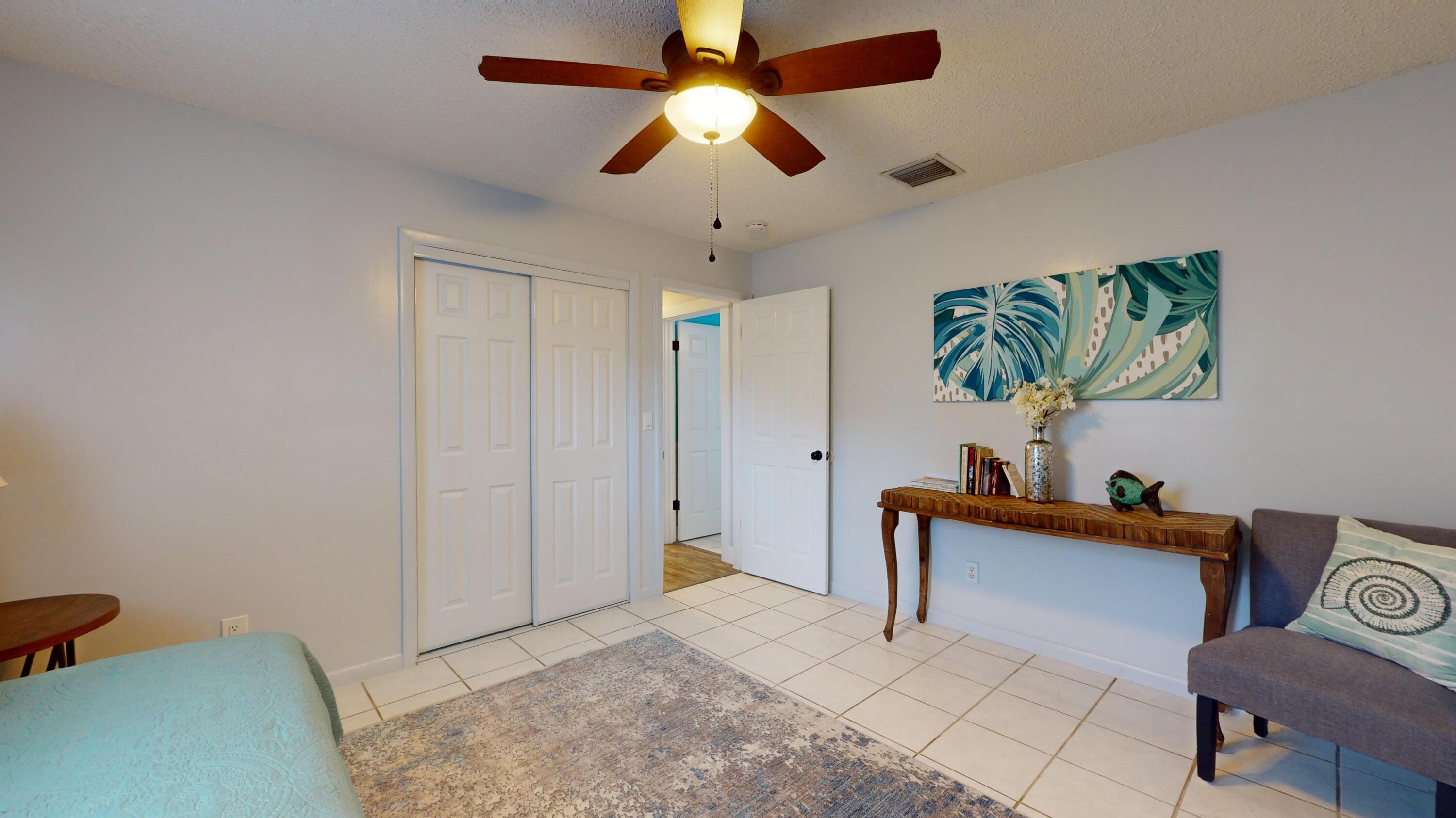 7606 Donlon Road Fort Pierce, FL 34951 - Photo 39 of 54 a bedroom with furniture and a chandelier