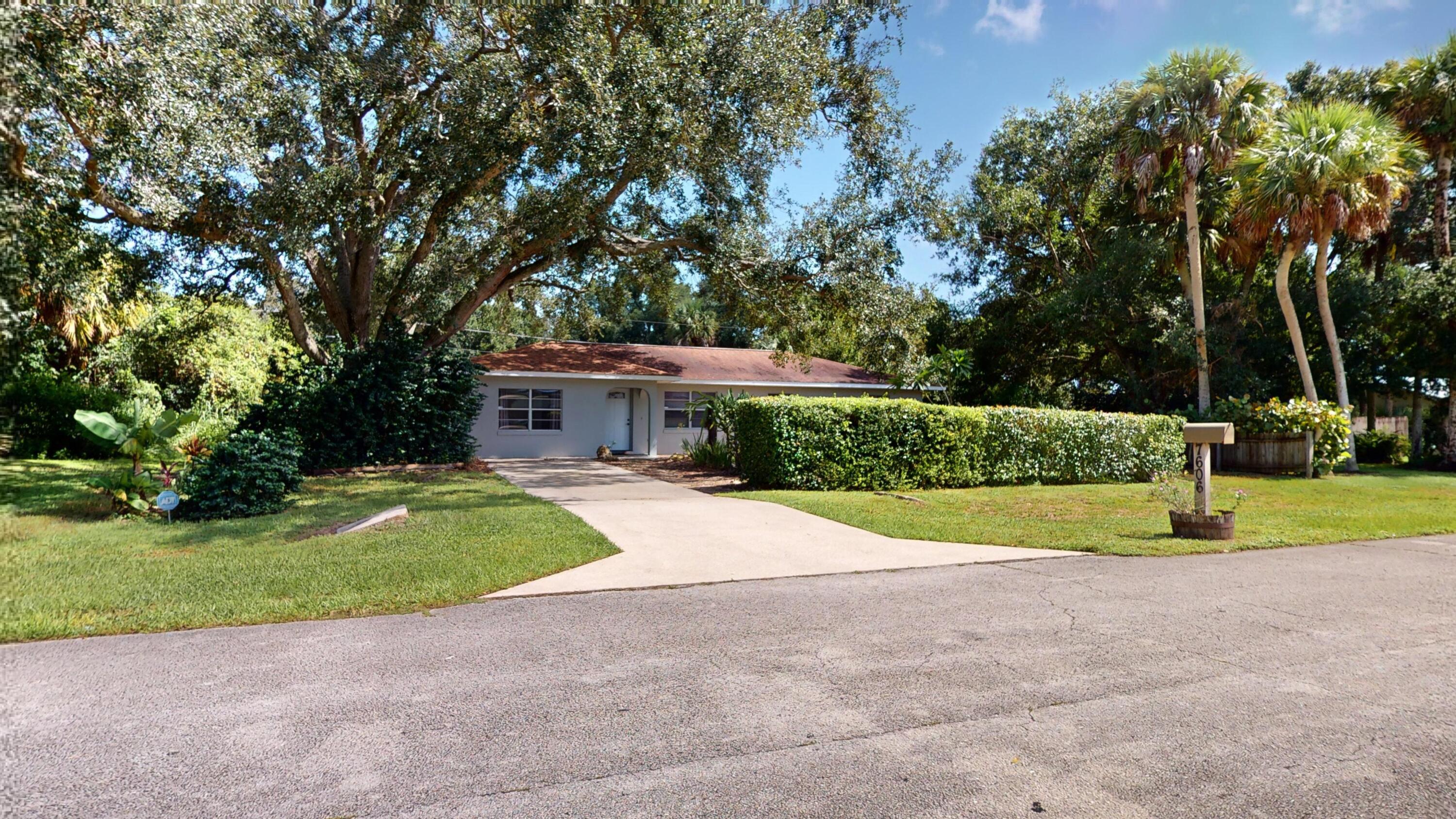 7606 Donlon Road Fort Pierce, FL 34951 - Photo 43 of 54 a view of a house with backyard and trees