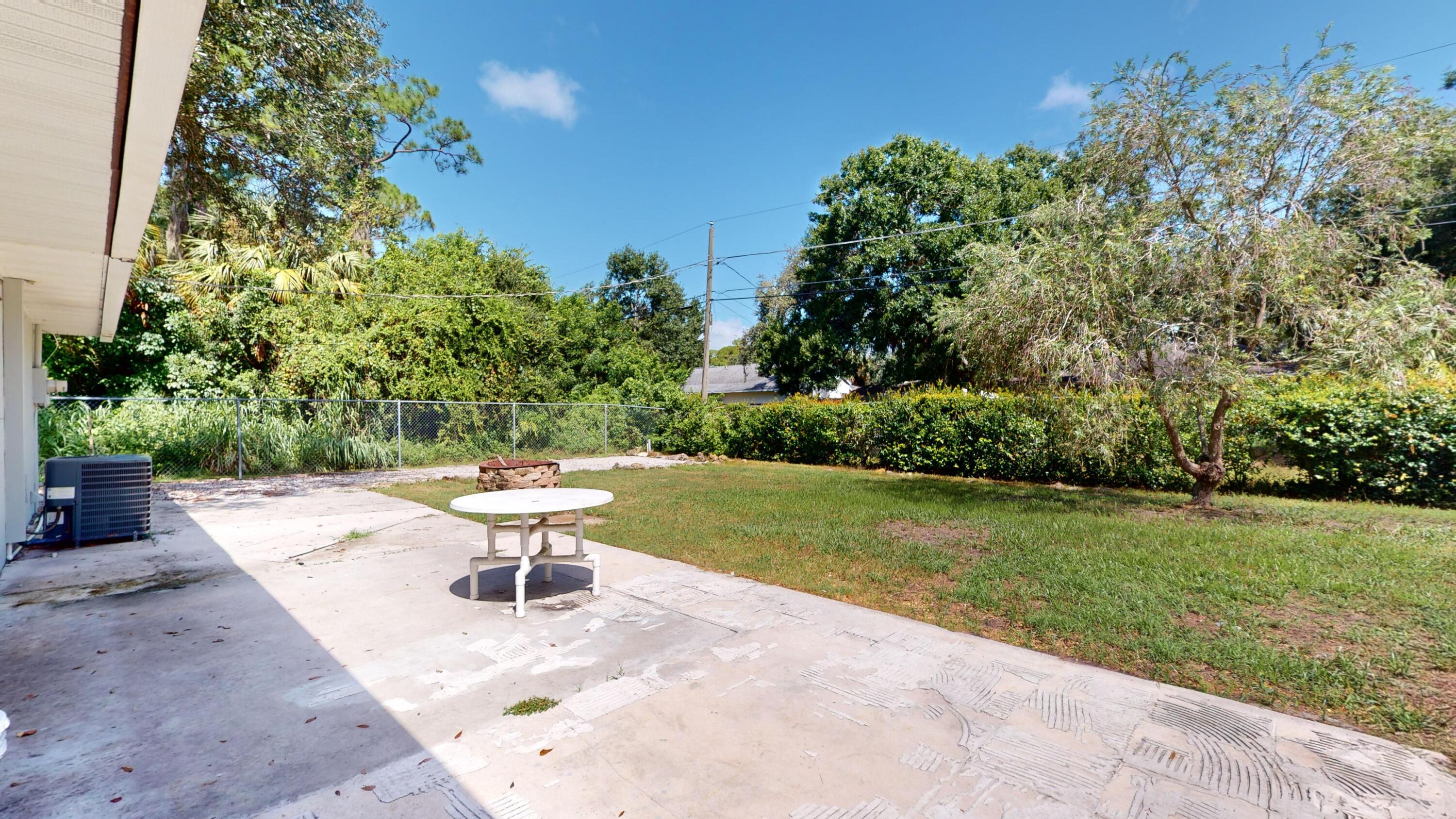 7606 Donlon Road Fort Pierce, FL 34951 - Photo 49 of 54 a white bath tub sitting in a yard next to a yard