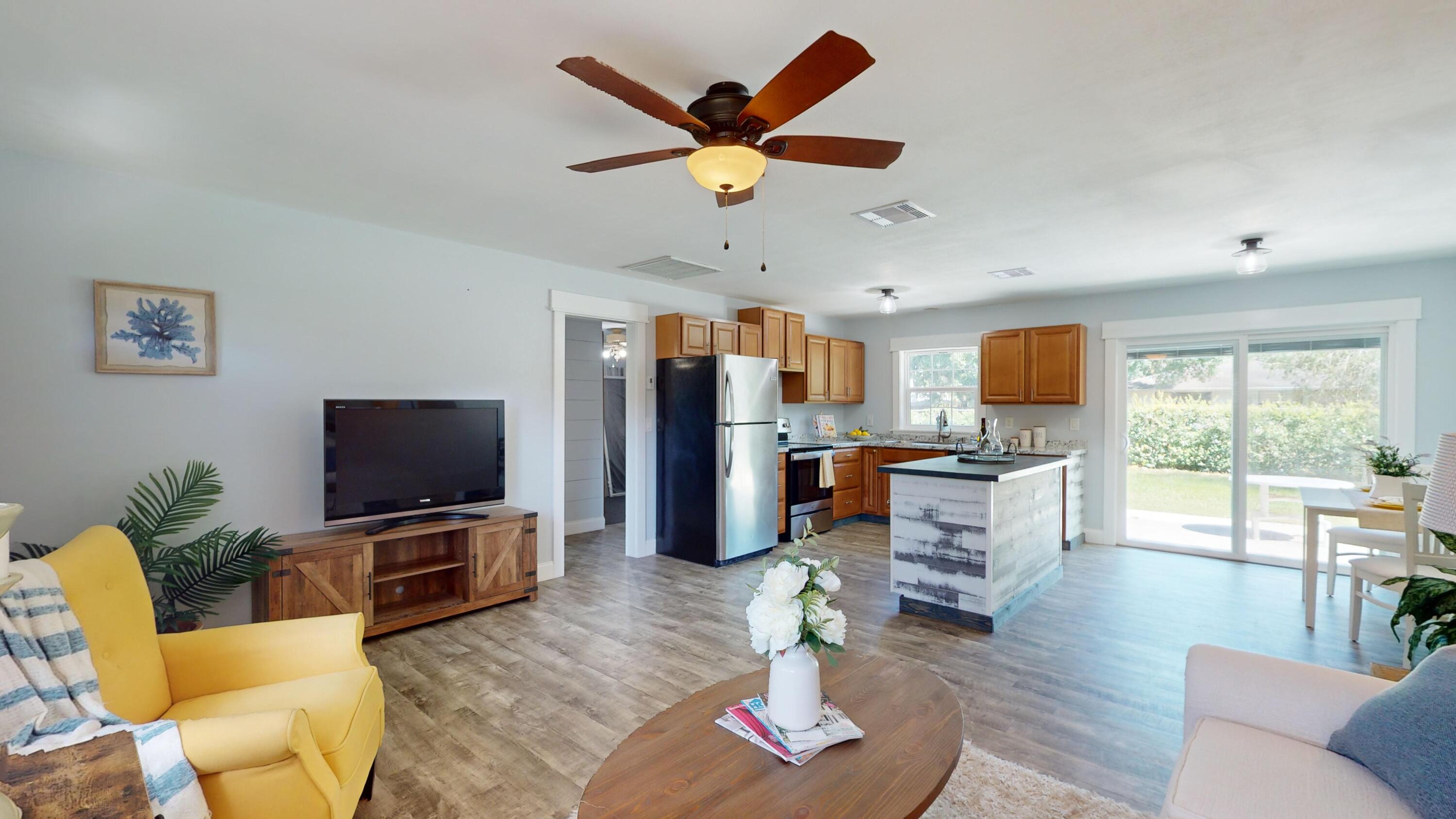7606 Donlon Road Fort Pierce, FL 34951 - Photo 6 of 54 a living room with furniture kitchen view and a large window