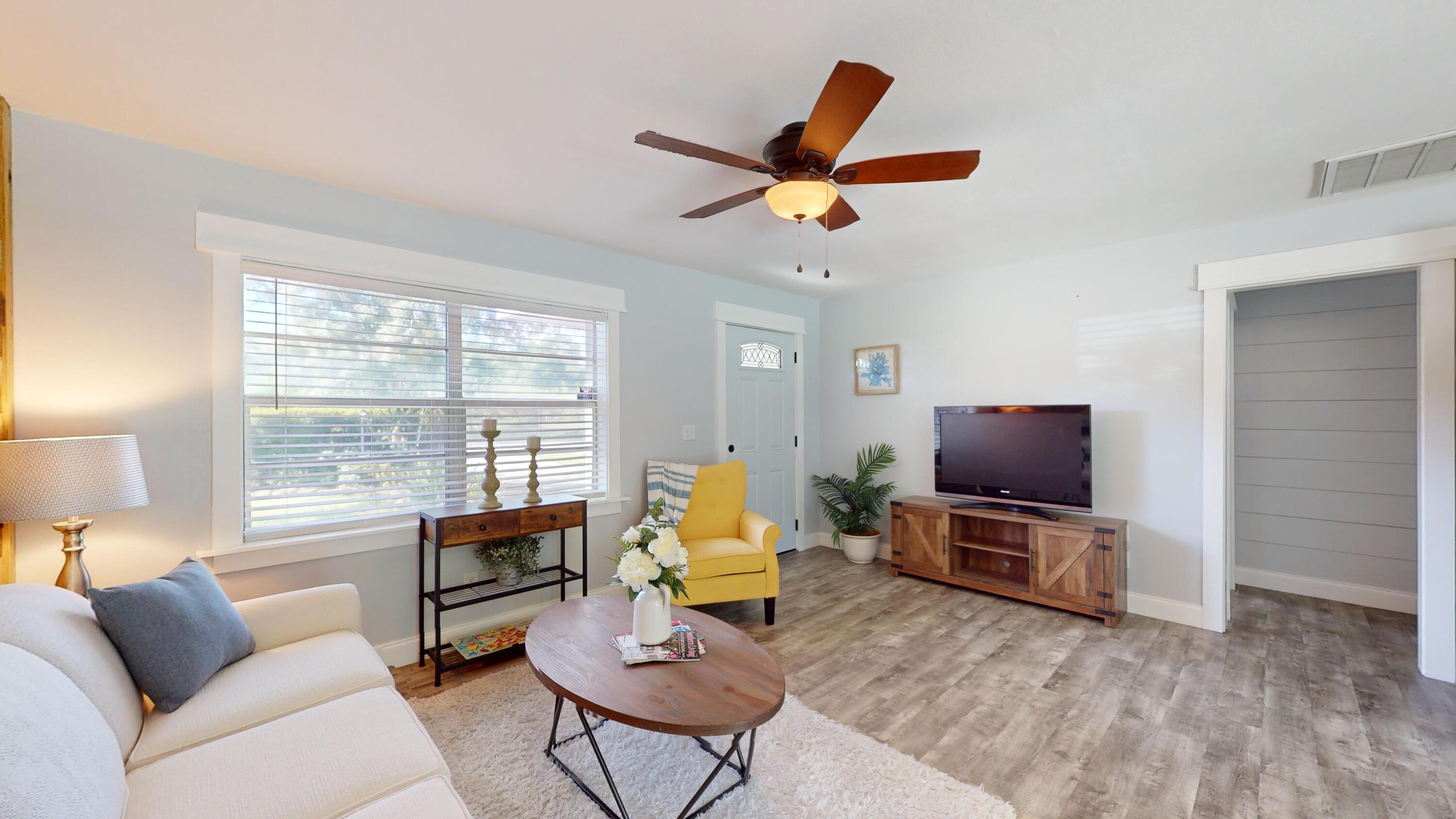 7606 Donlon Road Fort Pierce, FL 34951 - Photo 7 of 54 a living room with furniture and a flat screen tv
