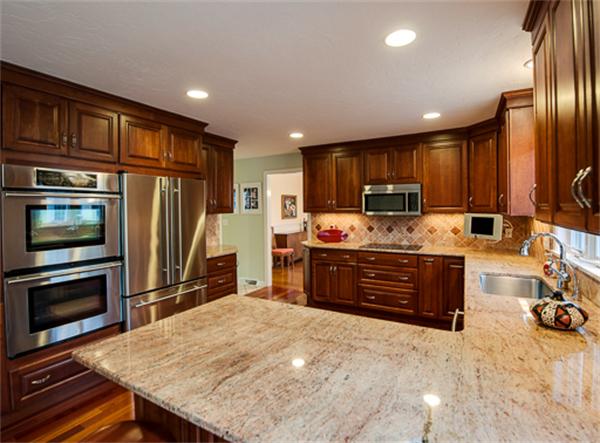 a kitchen with stainless steel appliances granite countertop a refrigerator stove and oven