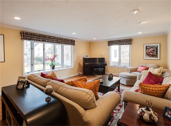 20 William Street Needham, MA 02494 - Photo 6 of 16 a living room with furniture a large window and a flat screen tv