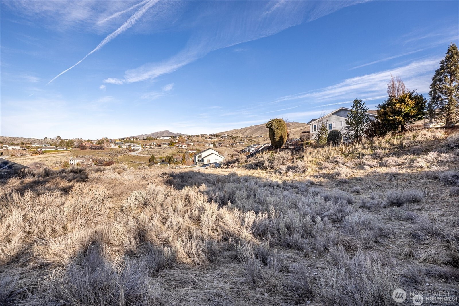 155 Stoney Brook Lane Wenatchee, WA 98801 - Photo 15 of 16 a view of a dry yard with mountains and valleys in the background
